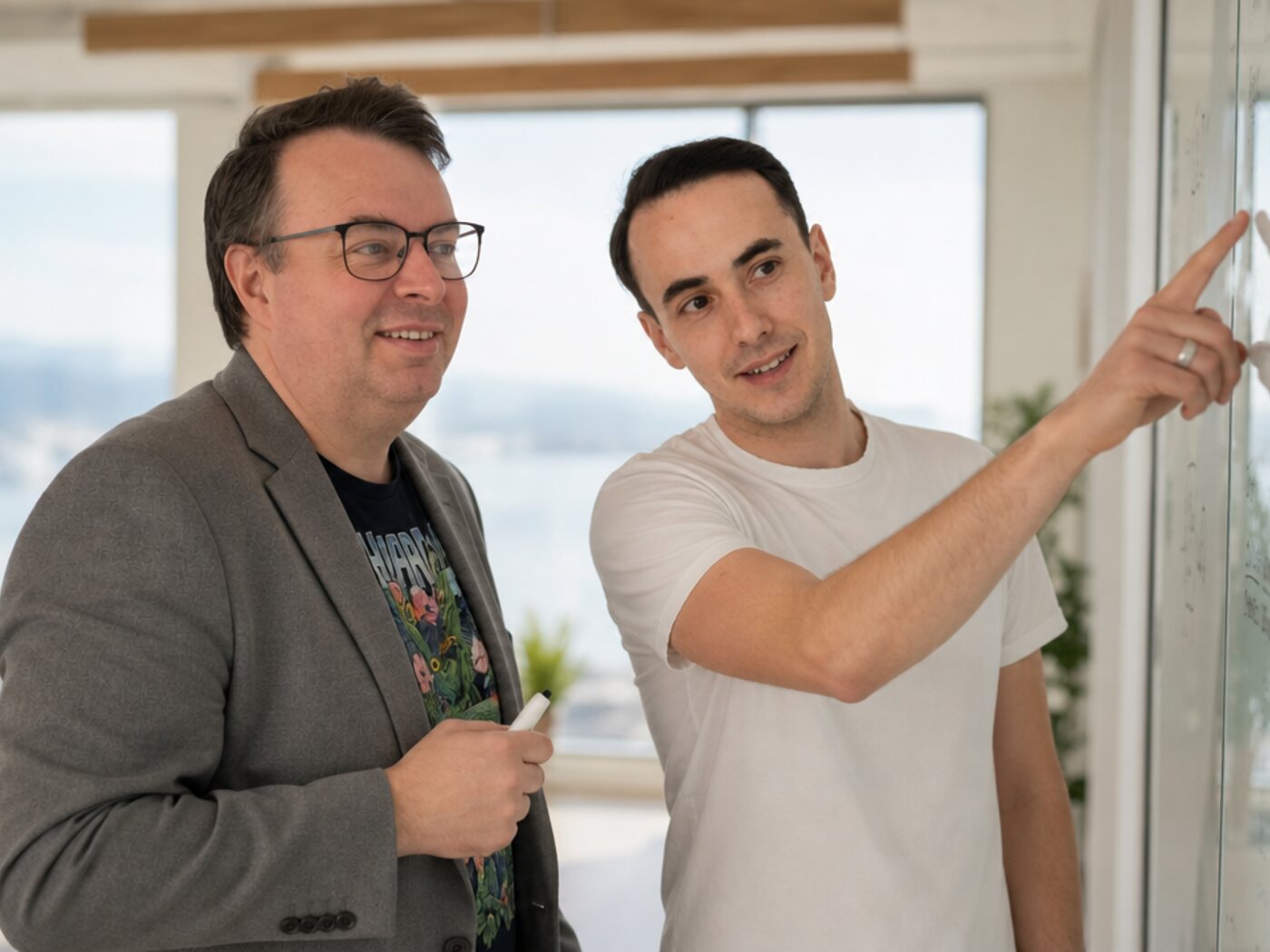 The two founders of Wolf Software Systems designing a customer's system at a whiteboard
