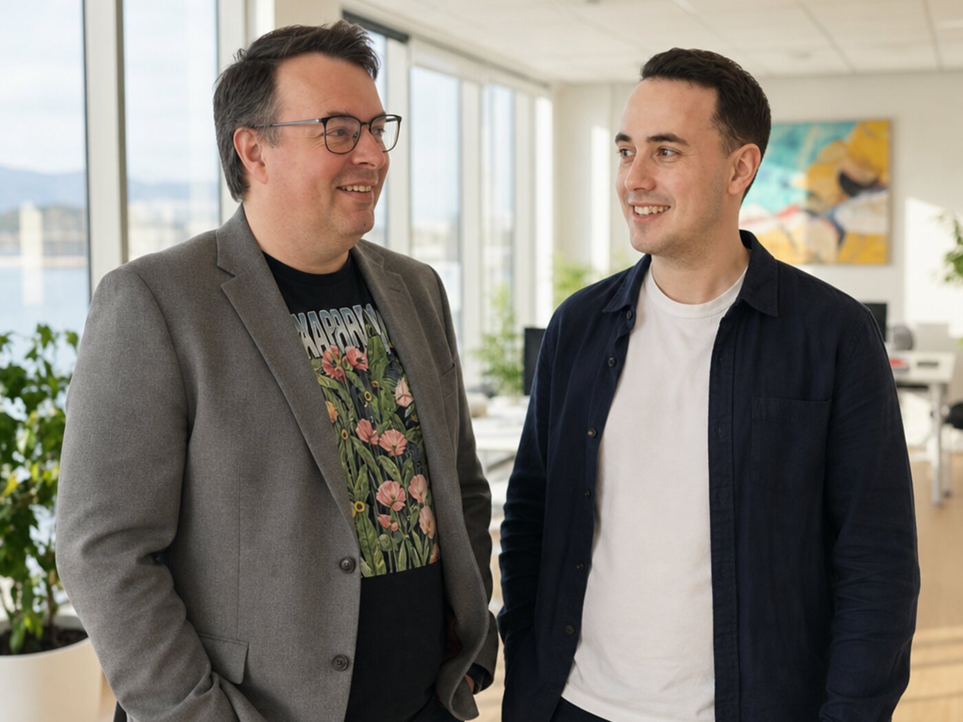 The two founders of Wolf Software Systems talking through a client's workflow in the office
